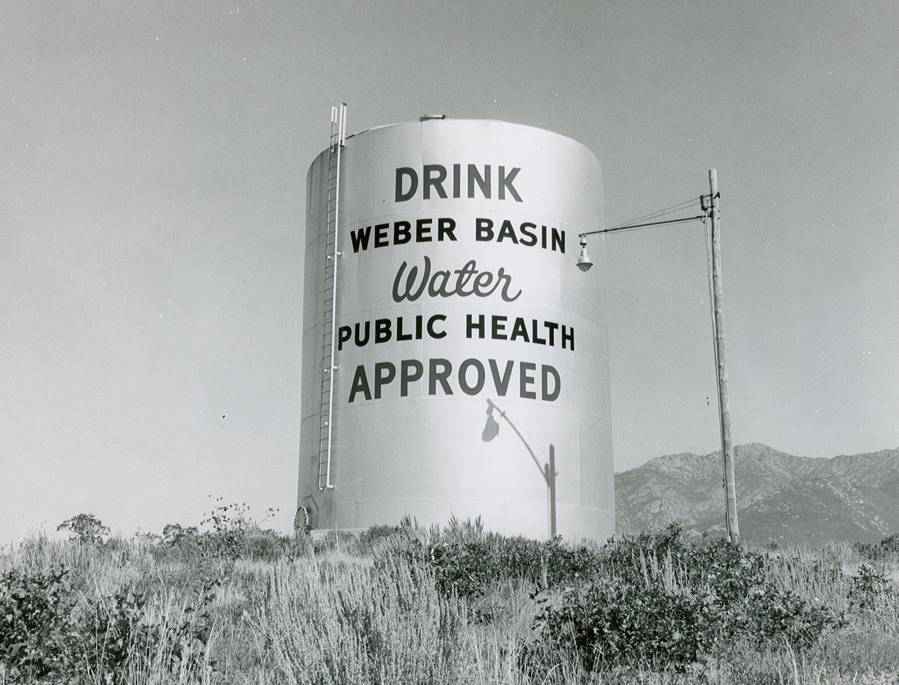 Large water tank with words saying Drink Weber Basin Water